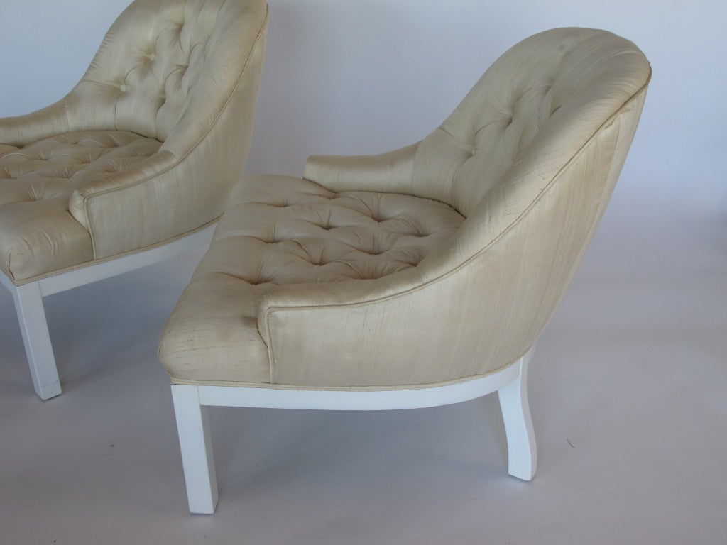 A pair of elegant tufted silk, slipper chairs.