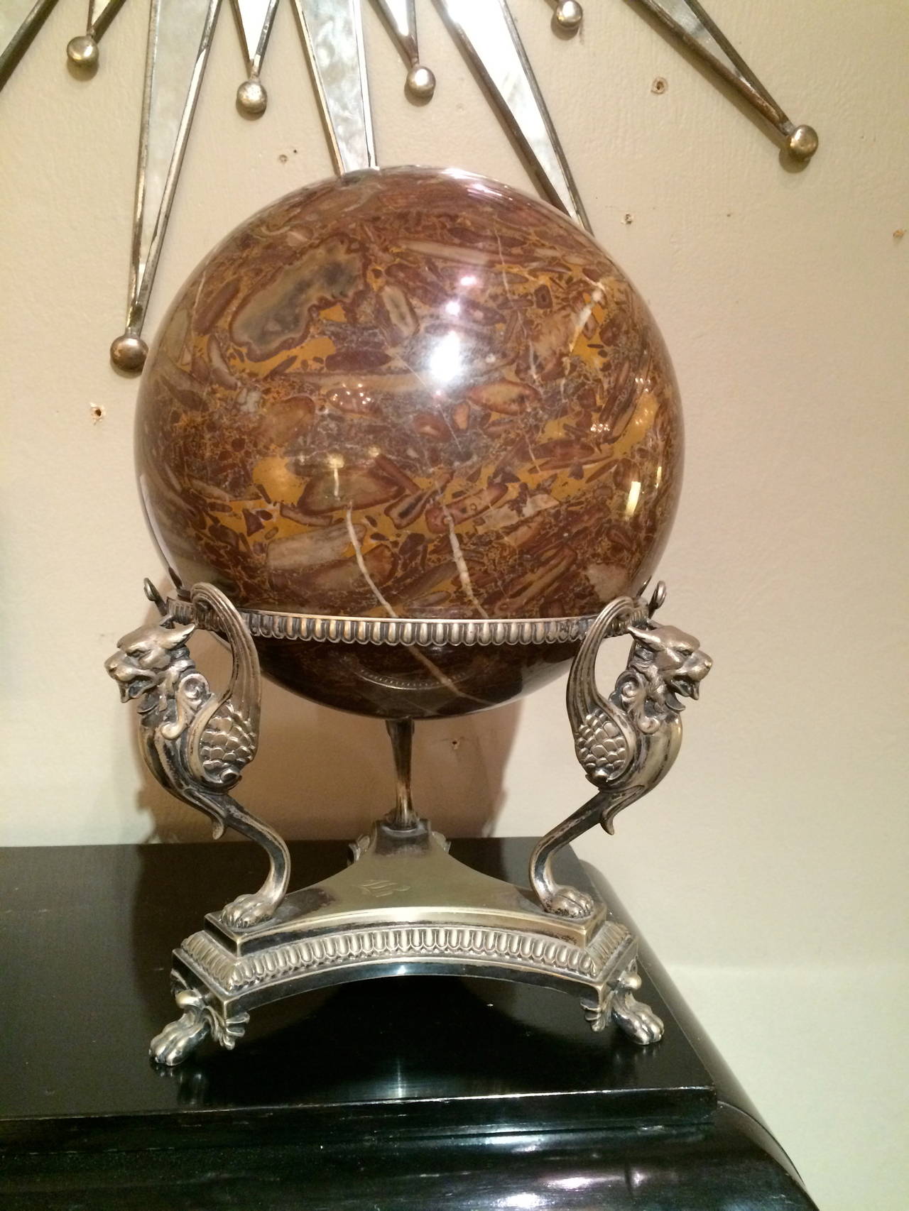 Large marble orb on a silver plated Edwardian tripod stand supported by winged griffins on paw feet. A unique decorative piece.