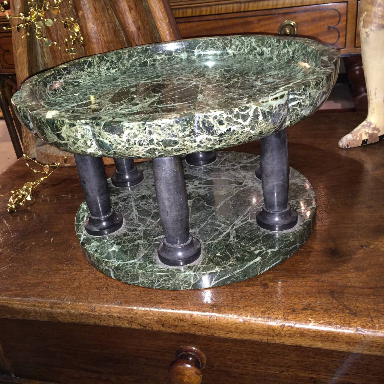An Italian hand-carved 'Antico Verde' and black marble tazza, the scalloped top supported by six columns. A distinctive table centerpiece in the Neoclassical style.
