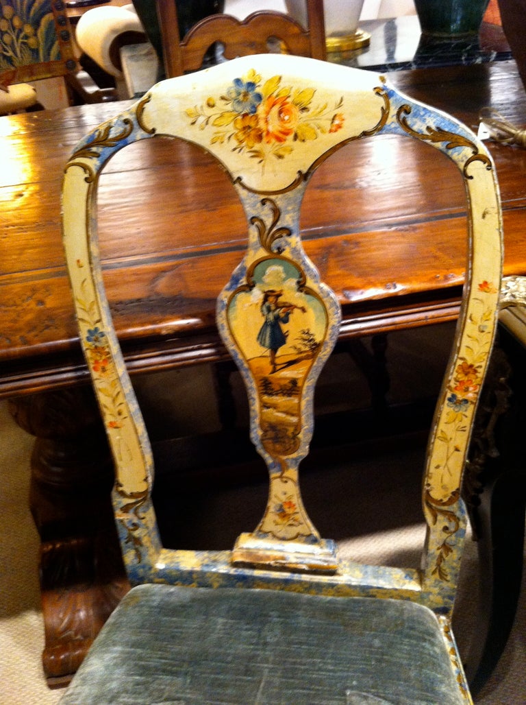 Charming pair of Rococo style Venetian painted and upholstered side chairs. The back splats painted with images of a musician and a cavalier.