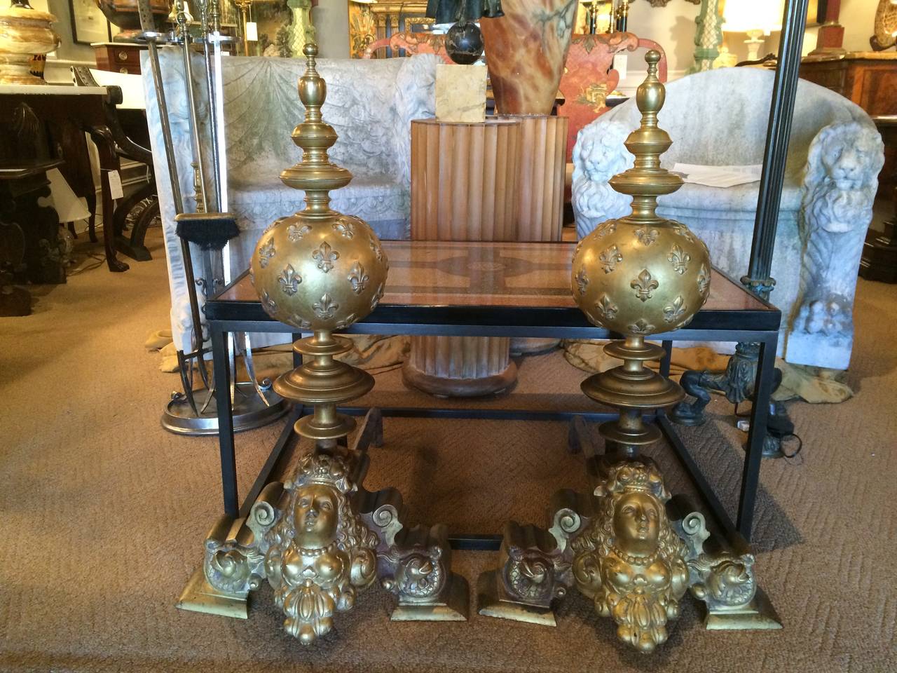 Fantastic pair of large-scale French Louis XV style bronze andirons. The bases depicting bare breasted goddesses looking upwards with curled serpents on either side, above a globe decorated with fluer-de-lys topped by a beautifully turned finial.