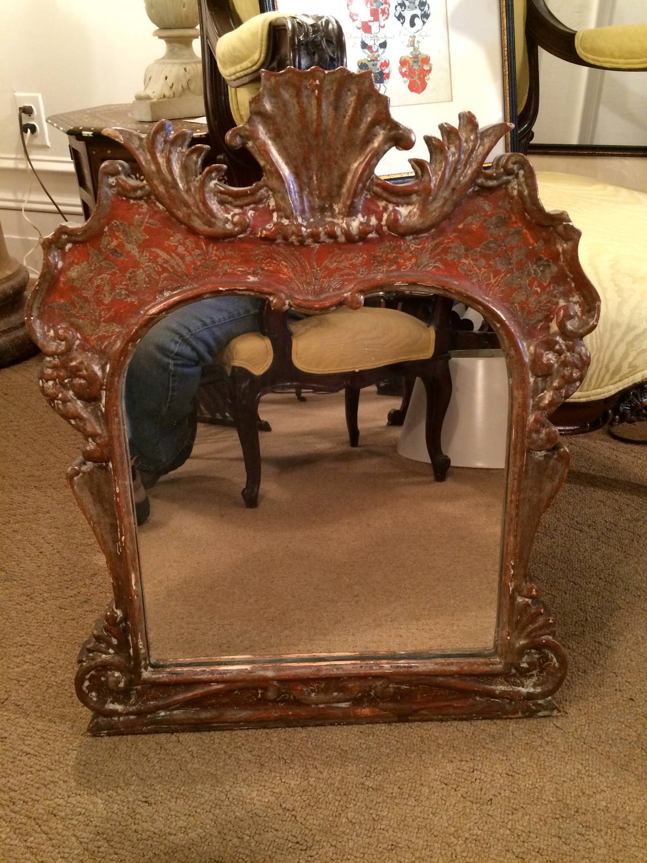 Elegant and charming Italian Rococo style Venetian red and silver gilt mirror with etched floral and arabesques surrounding a central shell motif.