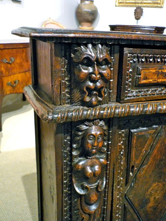 Best quality Italian early baroque walnut 'Prie dieu' or kneeler with robust carving of grotesques and female caryatids. Truly a marriage of the sacred and profane.