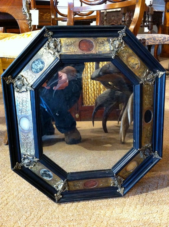 Great pair of 17th century Italian ebonized wood, etched bronze and hard stone octagonal mirror frames with winged female masks at corners and a border inlaid with ovals of stone.