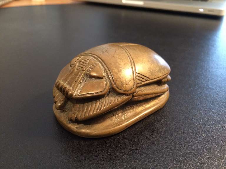 Grand Tour Egyptian revival bronze paperweight in the form of a scarab with hieroglyphics incised on the bottom. With traces of gilding.
