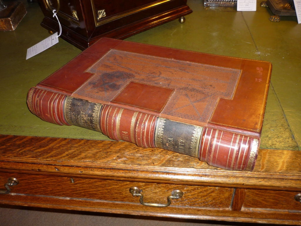 A handsome tooled and gilt leather book box with marbled paper lining. This is an old record ledger from Geauga County, Ohio that has been lined with beautiful marbleized paper and transformed into a box for valuables. Nice size at 18.5 by 13