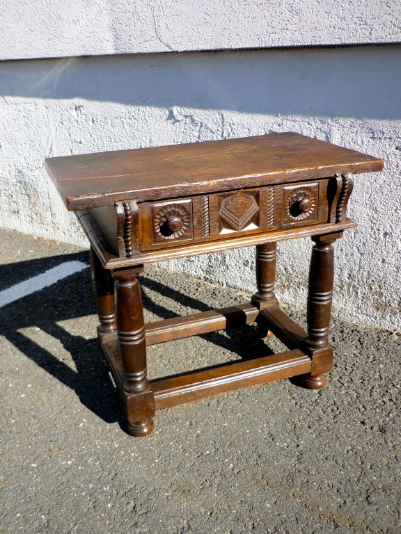 Spanish Baroque style single drawer walnut side table.