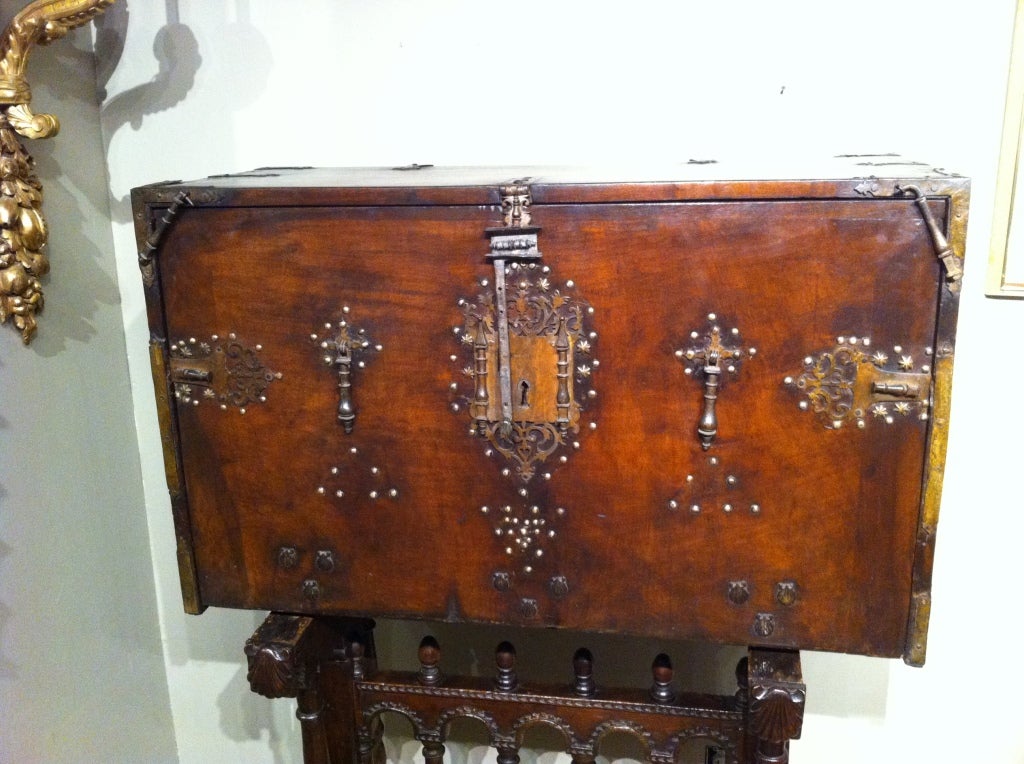 Exceptional 17th century Spanish walnut vargueno with gilt wrought iron hardware. The interior has architectural drawer fronts with ivory inlay and columns and shell form iron pulls. Two hidden drawers. Working key.
Vargueno top -24h 39w 17d