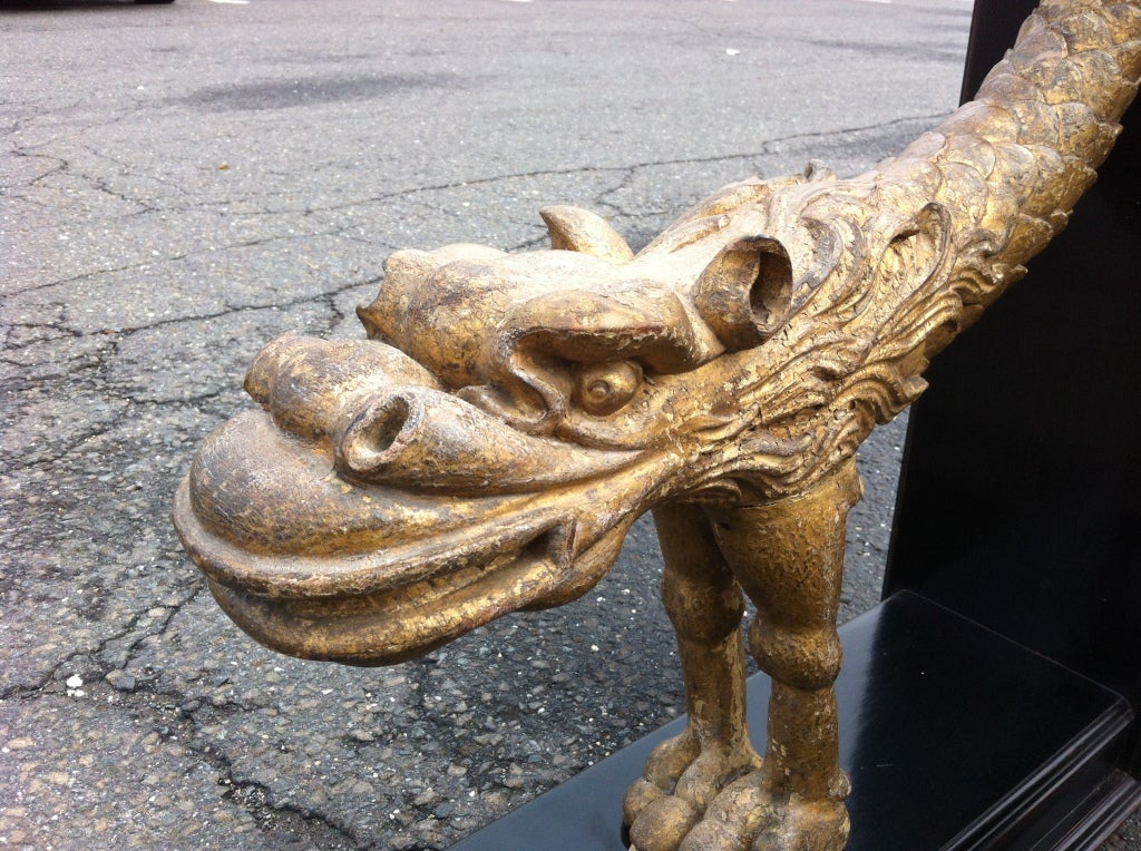 Unusual pair of carved gilt wood dragons or sea creatures on black lacquer stands. These wonderful carvings are Venetian Grotto 'Fantasy Furniture' architectural elements were possibly the arms to an elaborate chair, or architectural elements. The