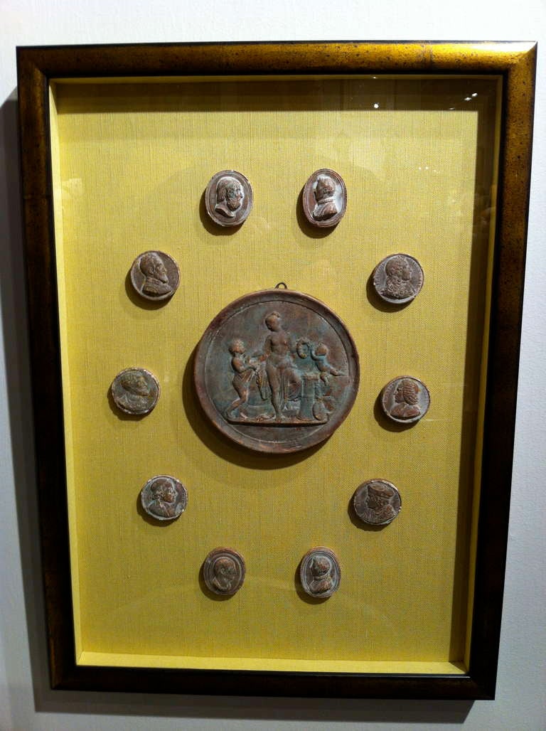 Wonderful set of ten framed Italian 'Grand Tour' intaglio collections depicting various famous personages and artworks. Plaster with an unusual warm terracotta finish. Mounted on yellow silk in gilt wood frames.

Can be purchased in pairs. $1800.
