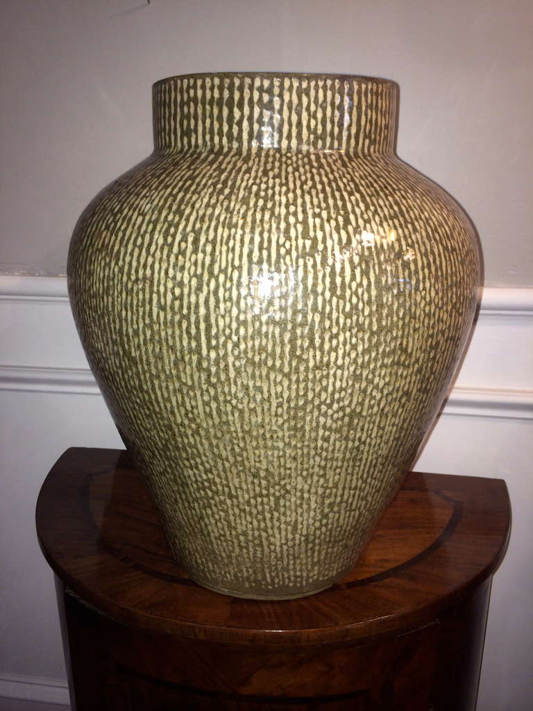Large scale Japanese ceramic jar with cream and celadon glaze. Classic form with subtle coloring.