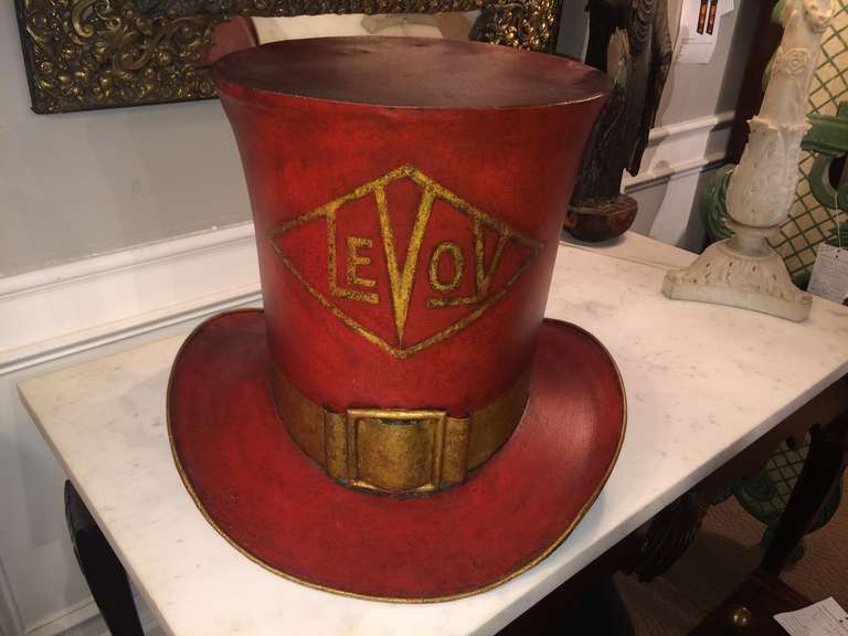 19th century American painted tin trade sign in the form of a top hat.  With gilt buckle, ribbon and the name 'Levoy' in a diamond cartouche. Original paint.

Price reduced and FREE SHIPPING