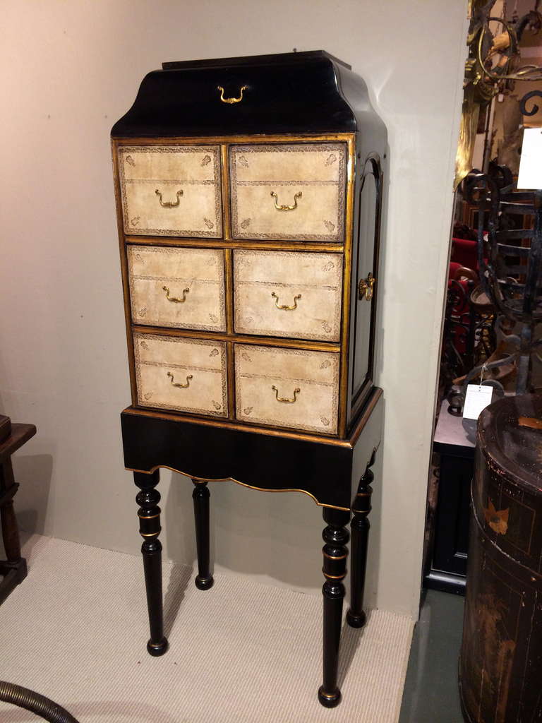 Beautifully made black lacquer and parcel-gilt cartonnier, or chest on stand, with tooled leather drawer fronts and gilt bronze mounts. In the French Regence style. A single drawer on top with six below. The chest lifts off of the base making it