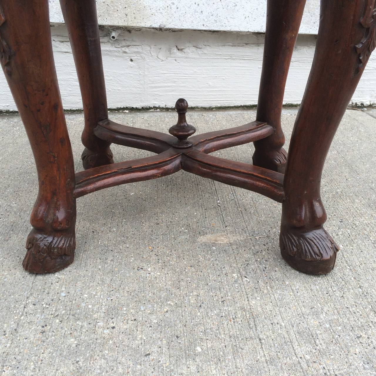 A fine 18th century Italian Baroque walnut stool with cabriole legs joined by an X-form stretcher ending in hoof feet. With blue and green Fortuny upholstery. Sturdy and quite comfortable. 