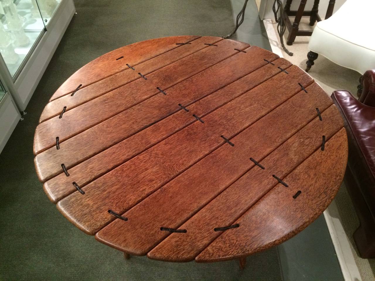 Palm wood dining or breakfast table. This handsome table is constructed of palm wood held together with leather wrapped steel.