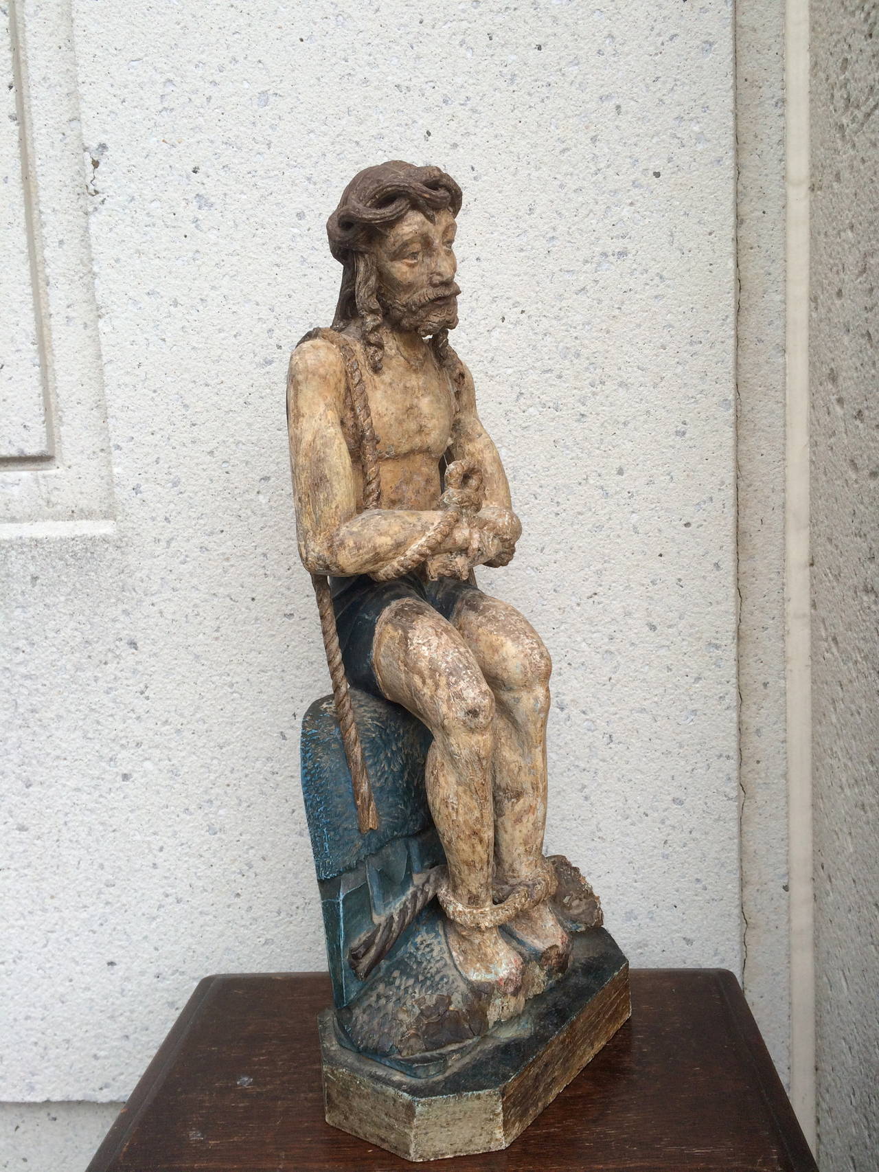 A mid 15th century Netherlandish oak carving of Christ on the cold stone with the original polychrome.  Christ is depicted here with the profoundly distraught expression that reveals the depth of his anguish as he waits to be crucified. 

To sit
