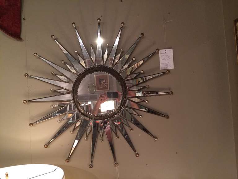 Handsome zinc double starburst mirror, good scale at almost 3 feet diameter.