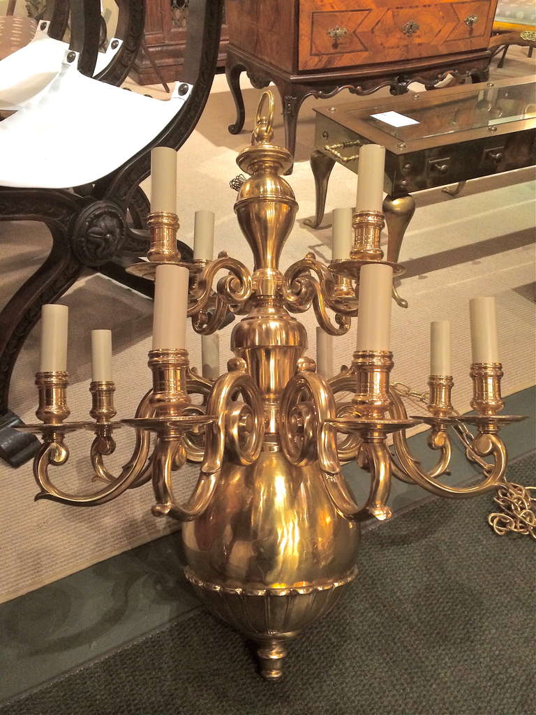 A Dutch Baroque style brass twelve light chandelier of impressive scale. A very gutsy fixture with real presence, it would be great in a foyer or entry way, as well an impressive dining room chandelier.