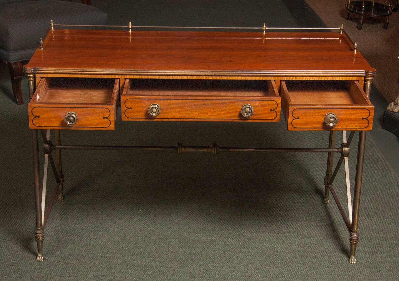 Classic, elegant rosewood Campaign desk in the English Regency style with bronze legs and stretcher, paw feet. Mid-Century, made by Kittinger, circa 1950.
