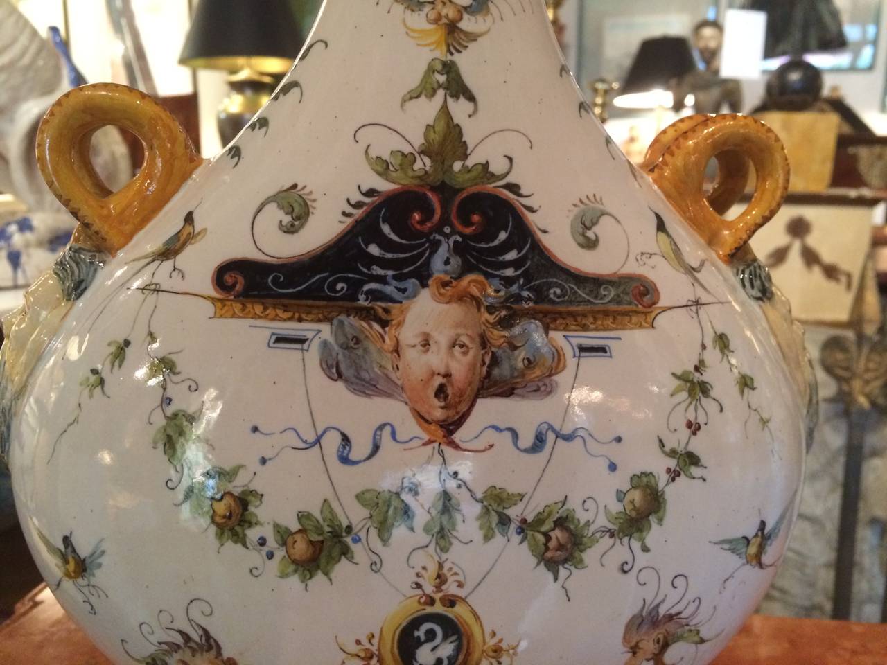 A very fine pair of Ginori Renaissance Revival glazed ceramic Maiolica pilgrim flasks now fitted as lamps with the original ceramic finials. Hand-painted throughout with amusing and exquisite Rapahelesque decoration typical of Ginori. Signed on