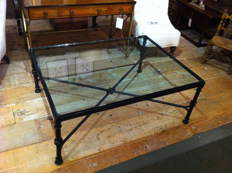 Quality cast bronze glass top coffee table in the style of Diego Giacometti. With rich dark patina and top with beveled edges.