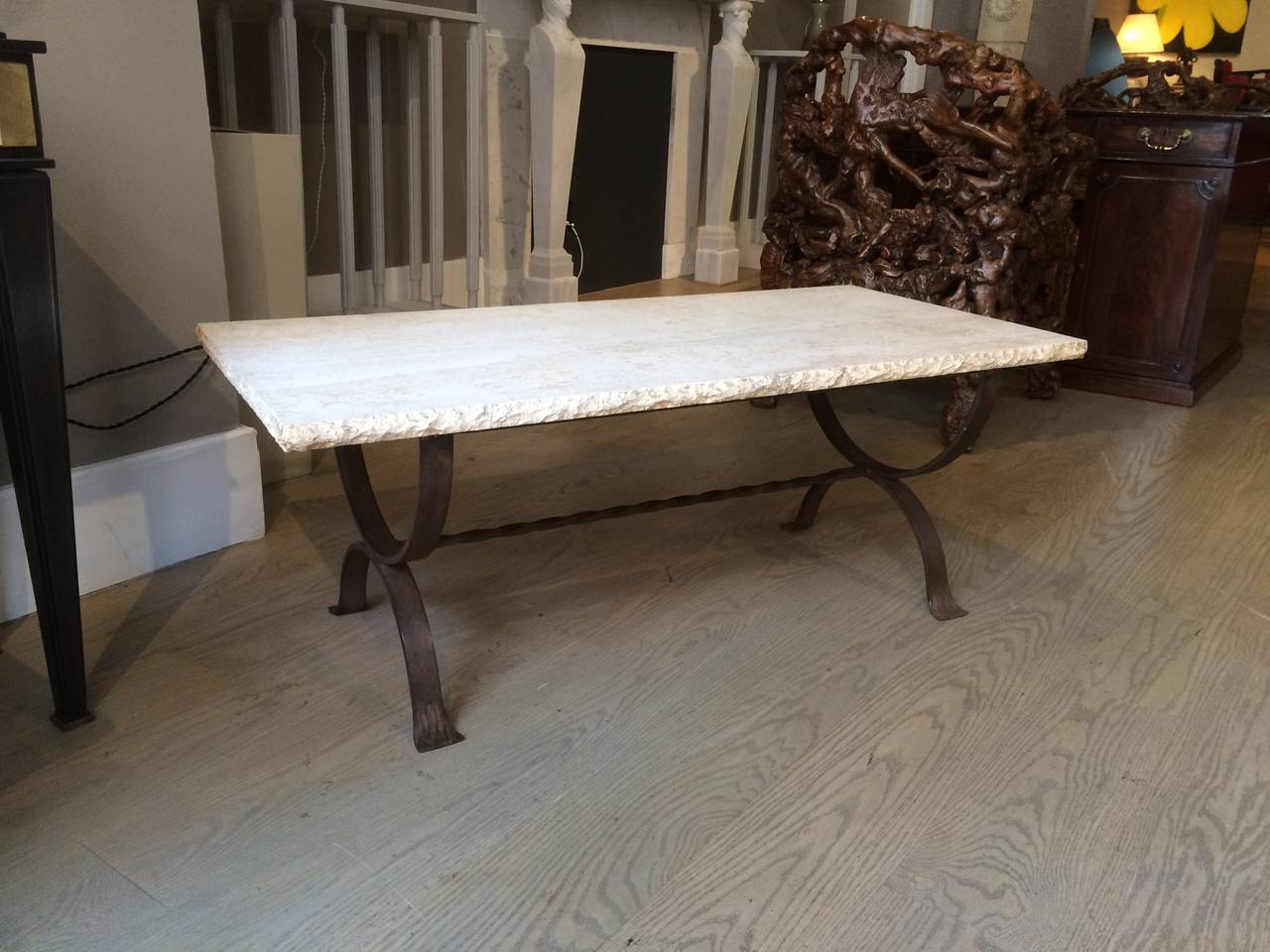 Italian wrought iron coffee or cocktail table with a stunning polished travertine top with roughed edges.