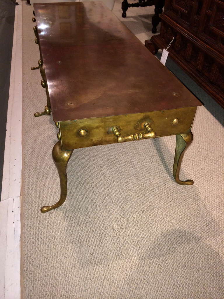 Unusual English brass 'footman' coffee table in the Georgian style, circa 1900. With great character and color. Could also be used as a bench.