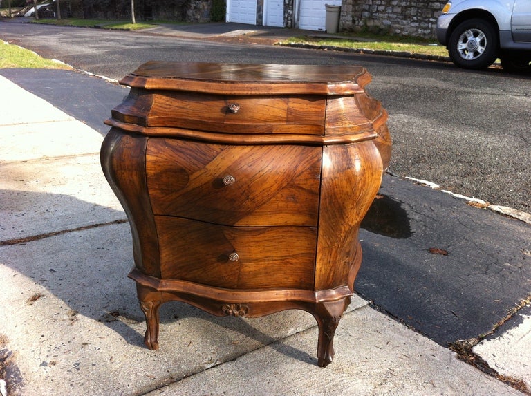 Voluptuous pair of Italian Rococo style olive wood bombe small three drawer commodes. Great as bed stands.