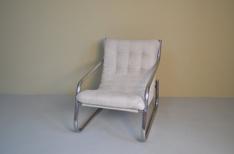 This chair has a distinctive profile and clever construction. Newly upholstered in fabric similar to the original.