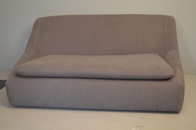 In a style reminiscent of the designs by Paulin, with its solid molded form. Newly reupholstered in velour.