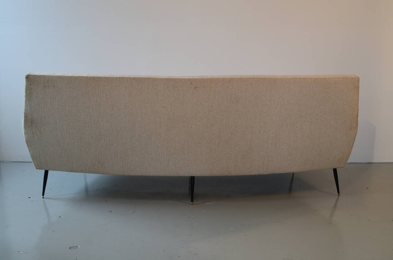 Curved sofa with metallic legs.