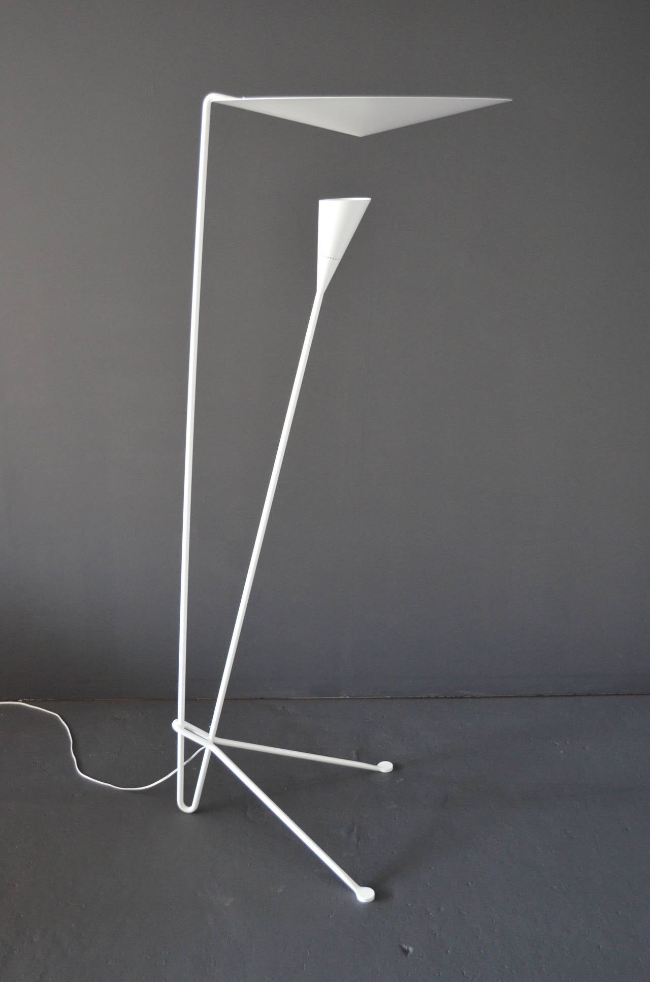 Dynamic lines and the innovative means by which the light is dispersed are signatures of this Michel Buffet Lamp. Light shines from the shade below to the conical disc above and is reflected out.

This lamp is only in white, as Michel Buffet's
