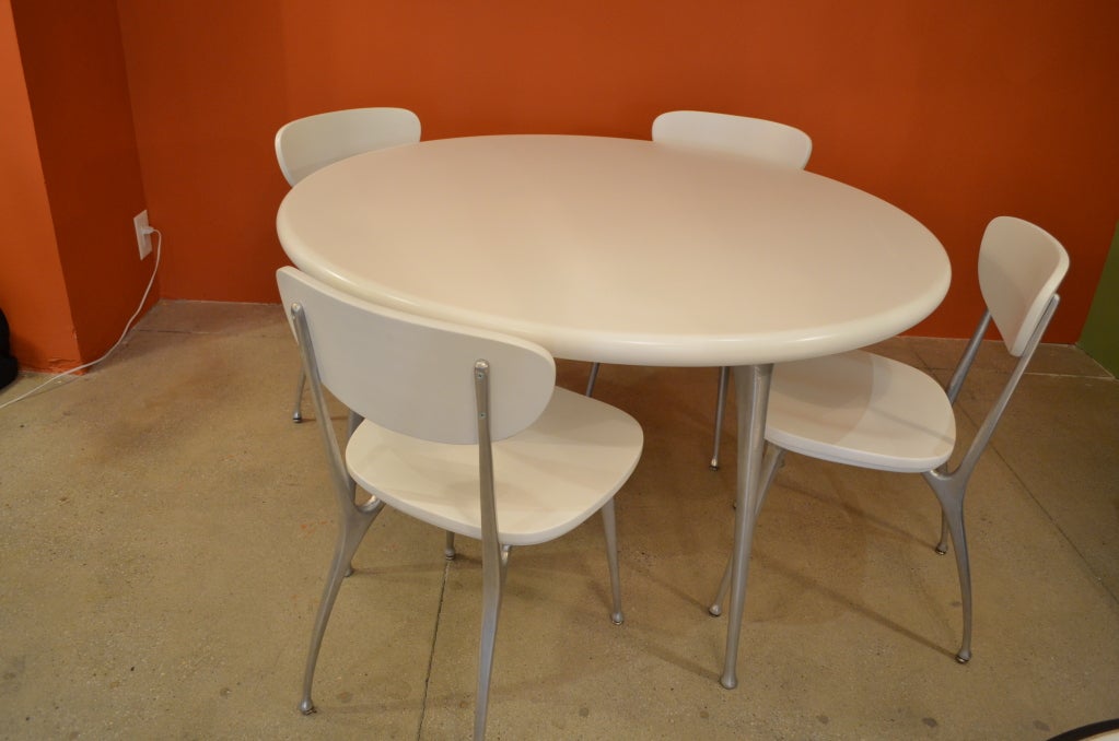 This beautiful dining set, newly redone with a smooth white satin finish that contrasts nicely with the brushed aluminum, features the 'Gazelle' design of Shelby Williams, with spindly, arching legs, at once refined and kinetic.