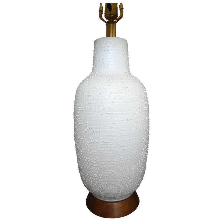 Beautiful white bumpy glazed ceramic lamp typical of Design Technics. 
The top of the finial measures 29".
The shade measures 9 x 16 diameter.
The ceramic measures 8 x 8 x 18 tall.
Below are over all measurements with shade.
The lamp sits