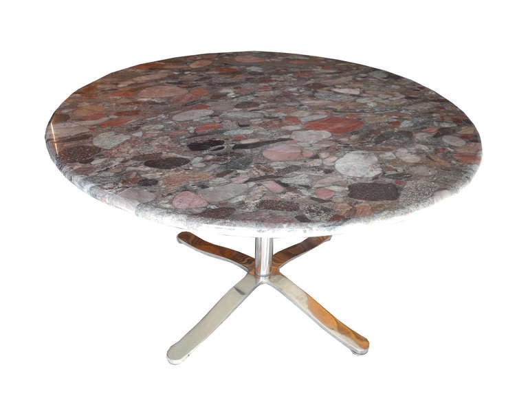 This marble dining or conference table is made of a unique multicolored stone top over a four point solid stainless steel polished base. The edge is a 1.25