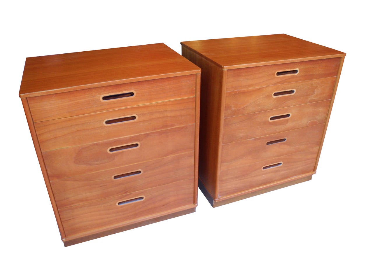 These six-drawer dressers or nightstands are made of mahogany.
The light warm stain shows off the grain of the wood. The detail of the inset handles which are inlaid with a lighter wood are also stained darker in the interior of the slot. The