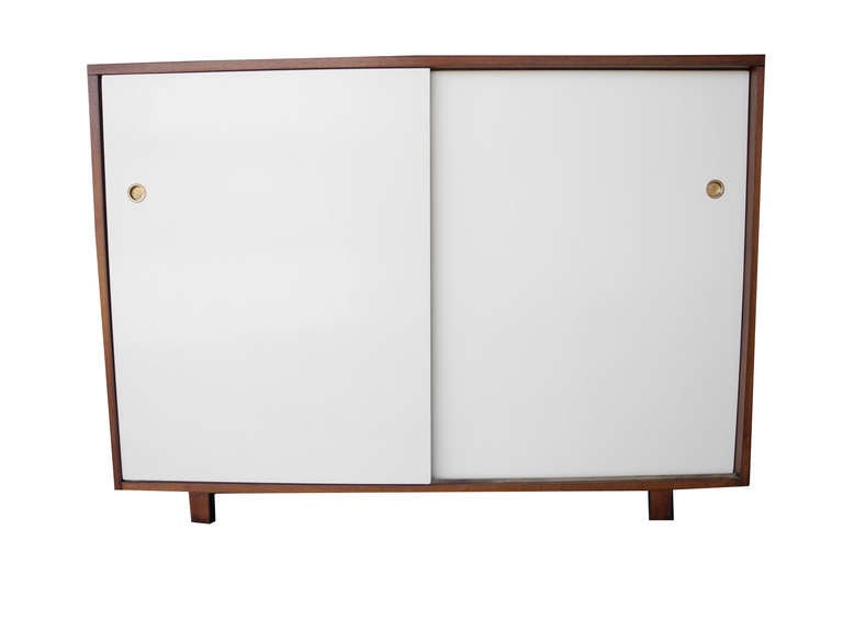 Plenty of organized spaces for your clothes.
Each cabinet has 6 small compartments and 7 drawers. The dressers including the doors are made of Mahogany veneer. The case is stained a medium brown and the doors are painted and lacquered in off white