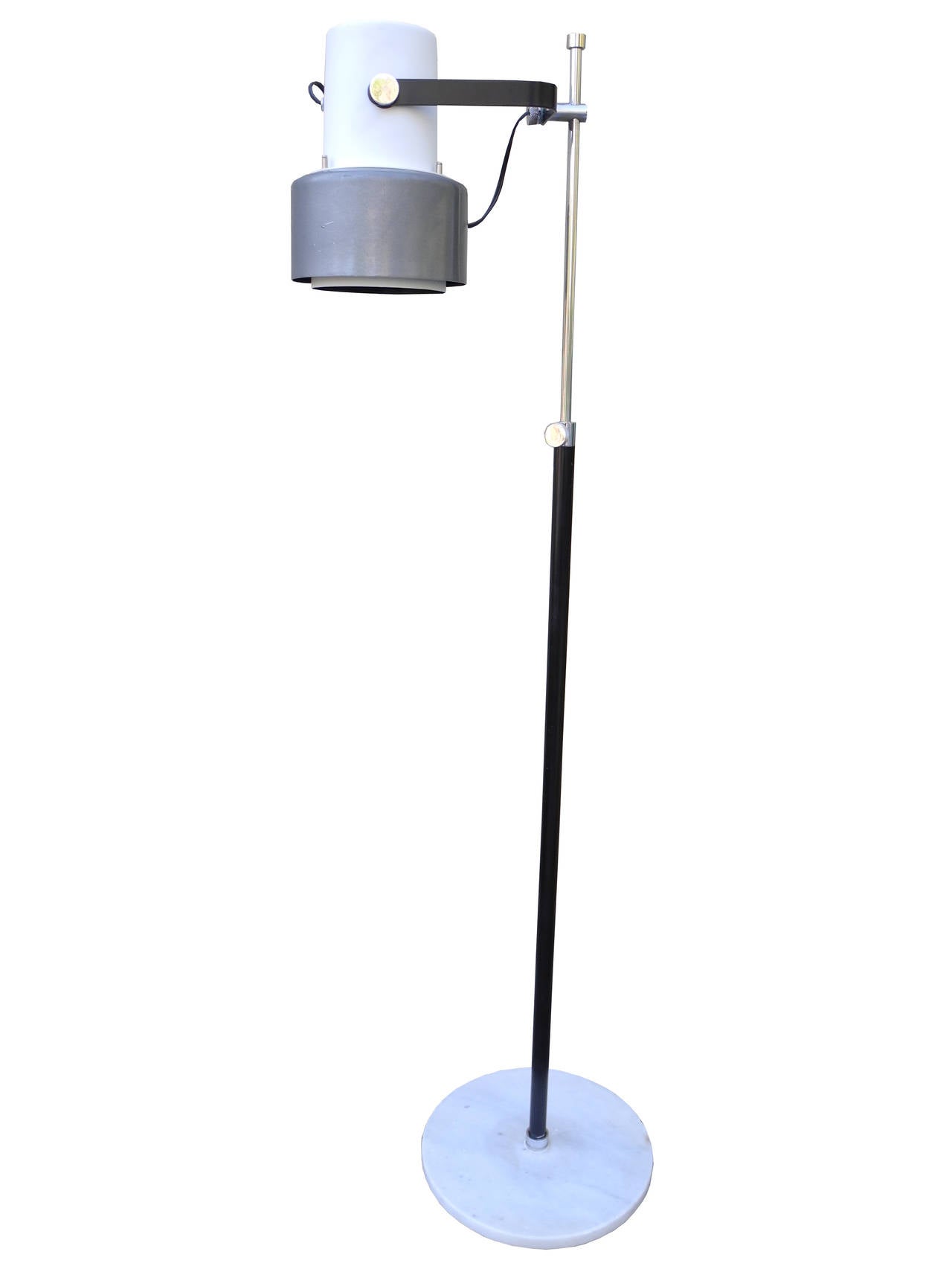 This vintage, made in Italy, floor lamp is in the style of Louis Poulsen. The base is made of marble and the shade of spun aluminum. The center rod is chromed steel. The shade moves up and down the rod and pivots as well. 100 watt bulb