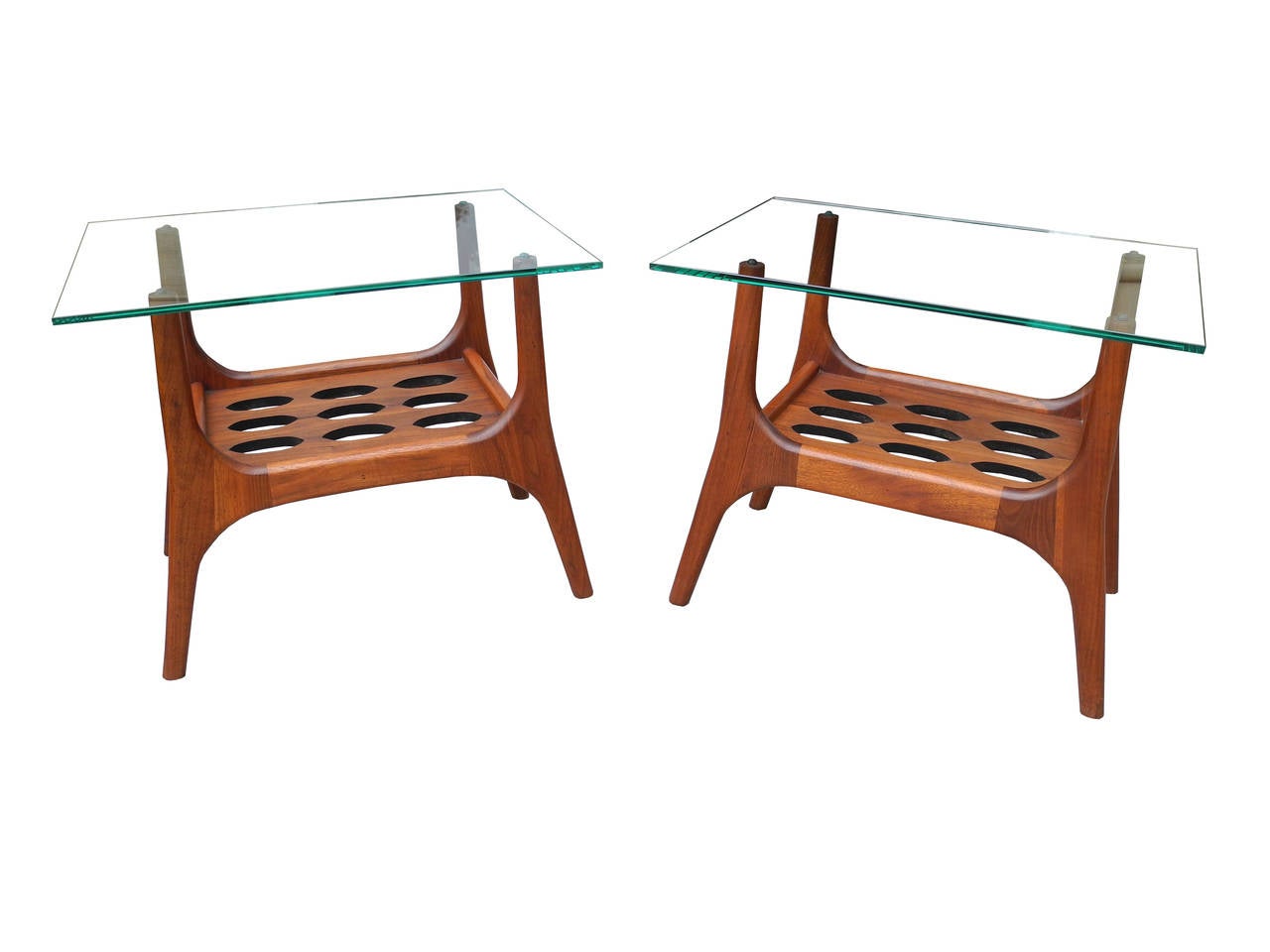 These organiclly shaped and sculpted nightstands are made of solid walnut.
Both equipped with a glass top and a center perforated shelf. Use them as side tables next to the sofa or next to the bed.