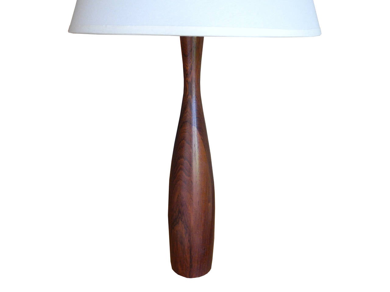 Made in Brazil of solid rosewood. The table lamp is petit.
Perfect for a small table, desk or nightstand. The top of the finial is 23.5