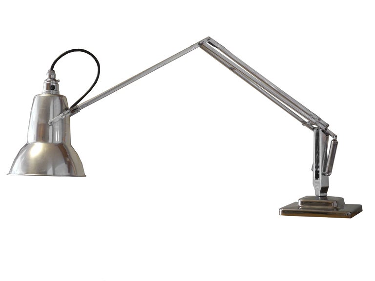 This is an original 1930's task lamp that has been fully nickeled, polished and rewired for American use. The shade is polished aluminum and houses a bayonet bulb. The lamp comes with a bulb. (You can purchase bulbs at Philips.com). The arm and base