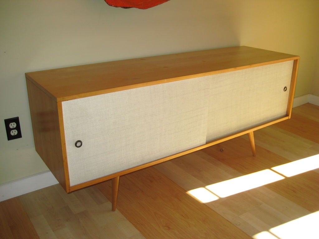 This is a great looking storage piece for the office or home. Low enough for the entertainment center to be placed on top. Each side has one  interior shelf. The doors are covered in the original grass cloth.<br />
<br />
For artwork, please visit