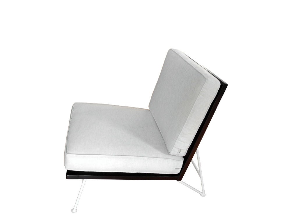 Originally designed for indoor and outdoor use these chairs were designed by Pipsan Saarinen-Swanson and Robert Swanson for Ficks-Reed. The pair was designed to have one with arms and one without. The cushions are new and have been reupholstered in