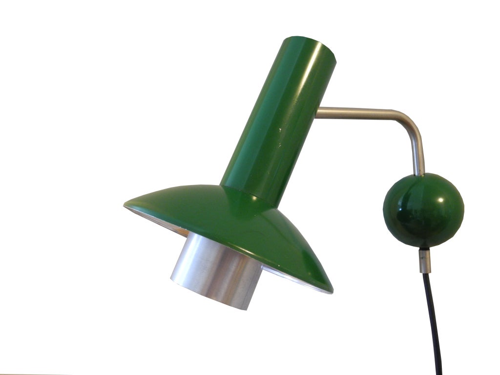 Fabulous pair of original Louis Poulsen lamps made in metal and factory painted primary green. The shade tilts and turns. The ball is a plastic cap that covers the screw plate. The switch is on the cord.