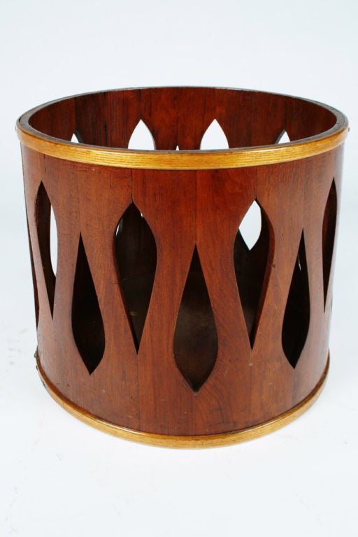 A mod wastebasket in staved teak wood with an abstract teardrop shaped piercing to its side.  By Jens Quistgaard for Dansk.  Danish, circa 1960.