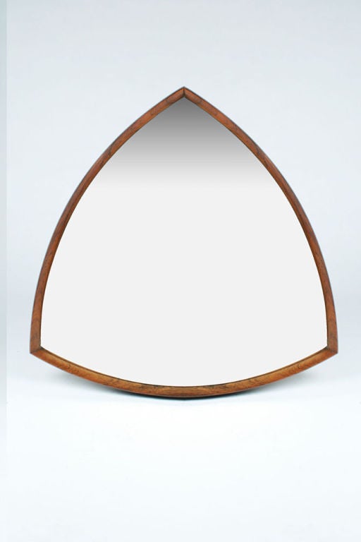 A beautiful mirror with a rosewood frame in a triangular form with bowed sides. Danish, circa 1960.