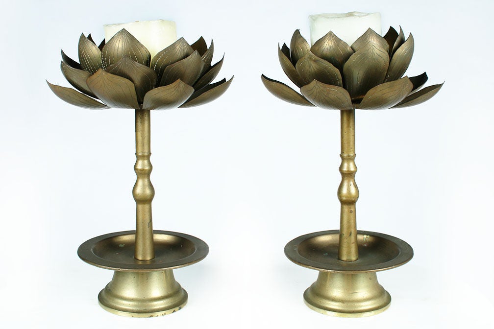 A delicate pair of candlesticks of brass in a lotus flower form with stamped detail to the leaves and turned stems and bases.  Hong Kong, circa 1970.