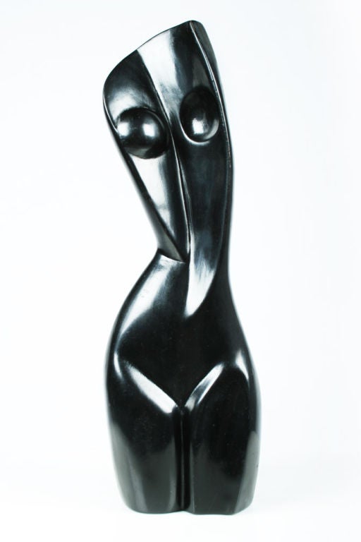 An ebonized carved wood sculpture in an abstract female nude form. This sculpture is beautiful from every angle. U.S.A., circa 1950.