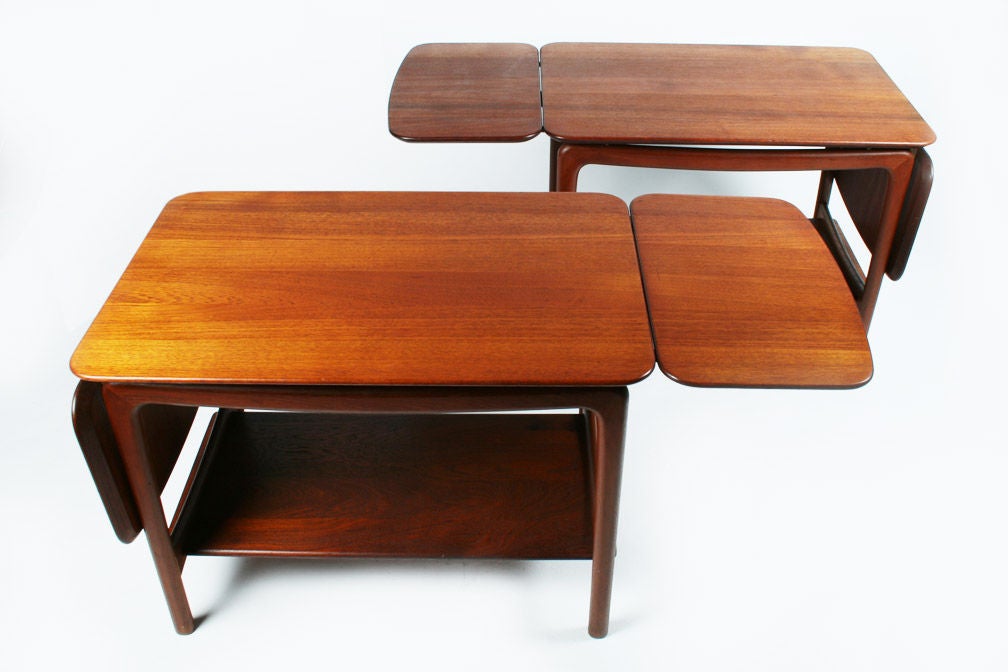 A beautiful pair of teak side tables tables comprised of double drop leaf tabletops (54 1/2