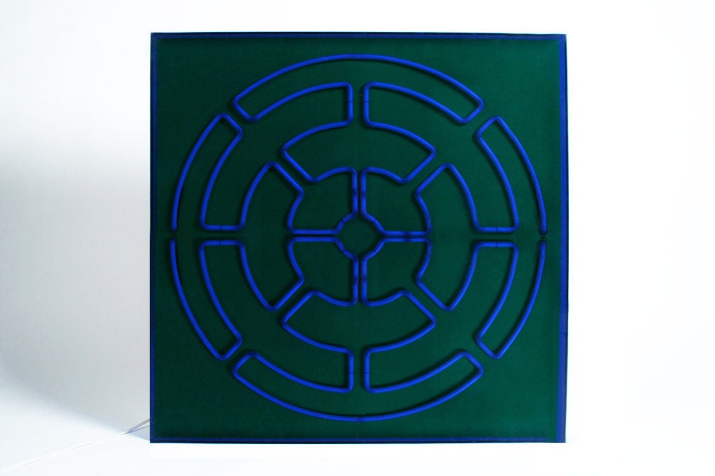 An Avant-garde wall sculpture with blue neon tubes in a maze-like sacred geometric formation mounted to plywood back and placed under blue Plexiglas designed and crafted by Christopher Sproat. Sproat is a Boston native who has been creating light